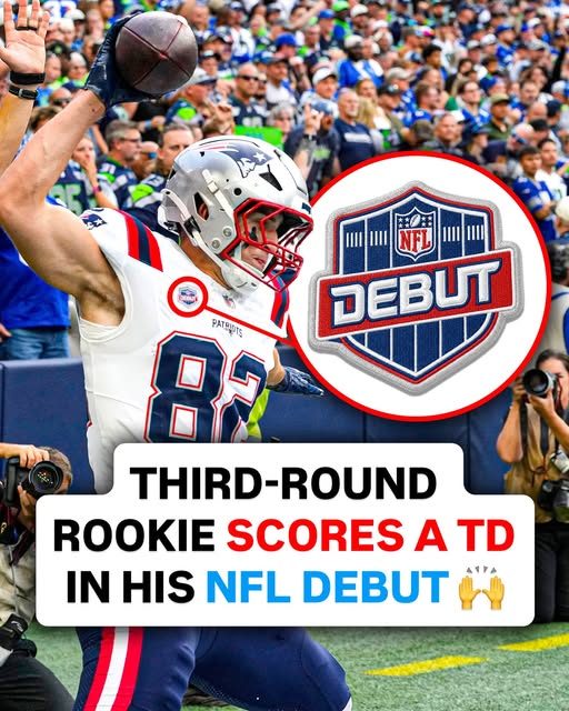 Eli Raridon spiking the ball after his touchdown at Seattle, the NFL Debut patch visible on his Patriots jersey.